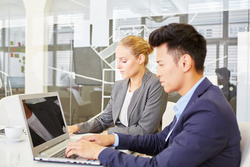 Businessman writing on laptop