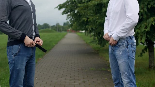 Two men unbutton their pants on the street, gays, homosexuality
