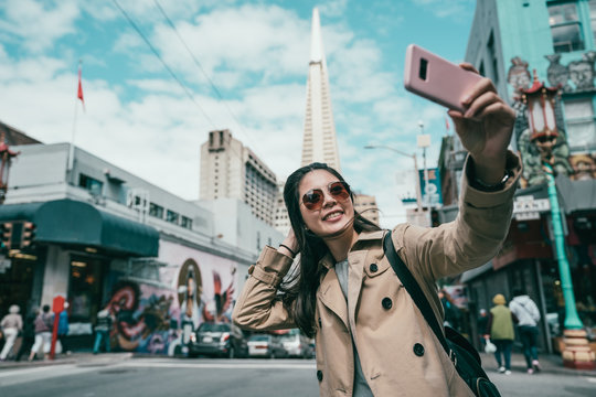woman taking selfies with a famous building