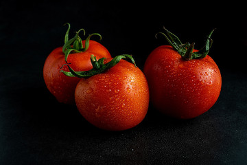 Tomatoes on black background