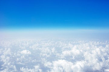 Beautiful Sky above the clouds. Plane window view with blue sky and clouds