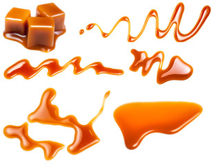 Caramel splashes isolated on white background. Spilled caramel sauce, toffee toppings