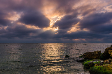 Sunset on the sea beach with stones