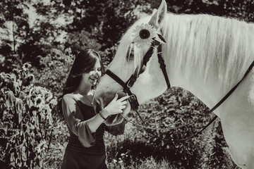 Young pretty woman hugging her horse - Concept about love between people and animals . Beautiful lady lifestyle with best friend horse in countryside. Portrait of human and animals for pet life 