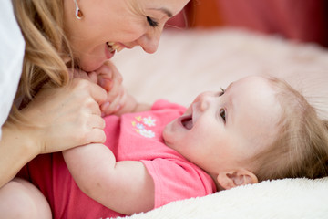 Happy mom and baby have fun pastime at home