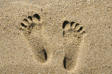 Foot step on sand beach background texture. Footprints on the beach sand