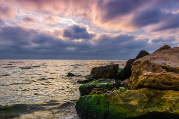 Fototapeta na wymiar Sunset on the sea beach with stones