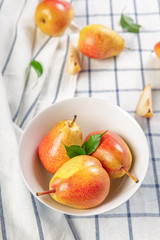 organic pears laying down on a lightly dotted kitchen cloth