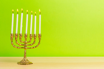 Bronze Hanukkah menorah with burning candles