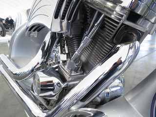 Chrome motorcycle engine parts close-up.  The engine and exhaust system in chrome of the motorcycle.