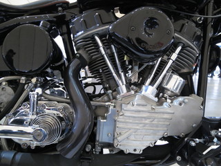 Chrome motorcycle engine parts close-up.  The engine and exhaust system in chrome of the motorcycle.
