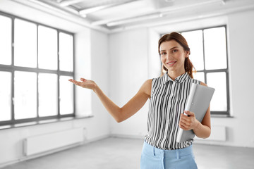 real estate business and people concept - businesswoman or realtor with folder at office