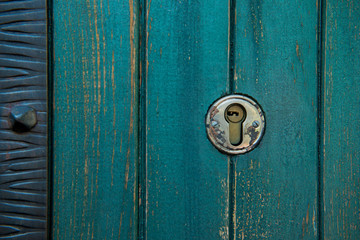 Old rusty and dusty keyhole wallpaper. Vintage keyhole on old wooden door background. Keyhole of old door.