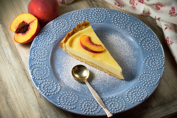 Cottage cheese casserole with sour cream on white plate. Cottage cheese baked pudding peach