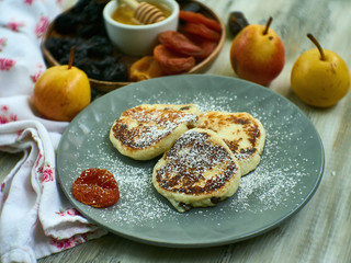 Cottage cheese casserole with sour cream on white plate. Cottage cheese baked pudding peach