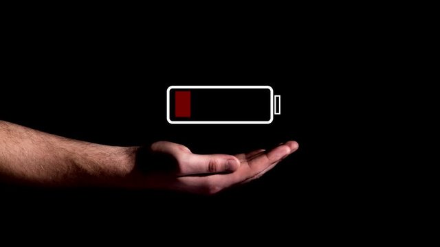 Hand showing Battery Charge icon on black background