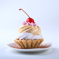 Tasty Homemade cupcake, muffin with cream and cherry. Close up view delicious sweet dessert isolated on white.