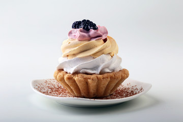 Tasty Homemade cupcake, muffin with cream and raspberry. Close up view delicious sweet dessert isolated on white.