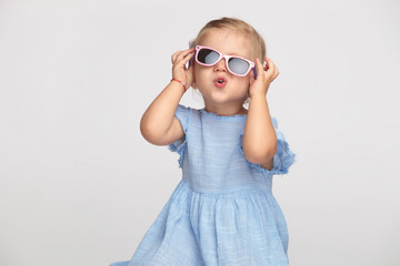 cute little girl fixing her sunglasses