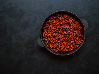 Goji berries on a black background.