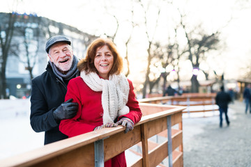 Senior couple on a walk in a city in winter.