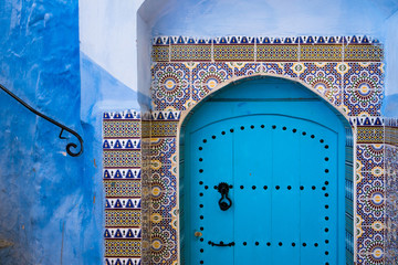 Traditional doorway with arabesque decoration in Chefchaouen in Morocco