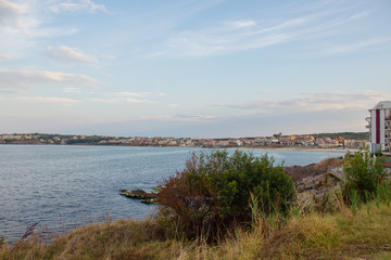 Coast with rocks and grass and the sea