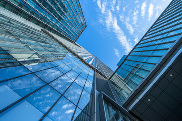 Plakat Modern office building against blue sky.