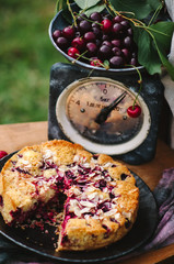 Homemade cherry pie on a wooden chair in the garden
