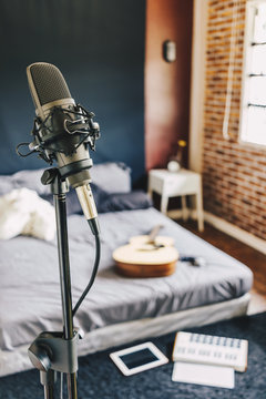 bedroom studio. home recording studio. microphone, musical instrument and recording equipment in bedroom