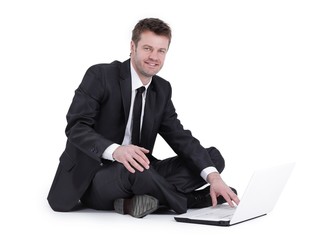 businessman with laptop sitting on the floor.