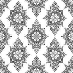 Seamless decorative pattern in ethnic oriental style. Mandala and flower in mehndi style.