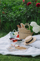 Picnic wicker basket with food on on the grass. Picnic concept.