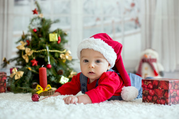 Portrait of newborn baby in Santa clothes and christmas hat