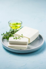 Feta cheese with herbs and olive oil. Selective focus, space for text.