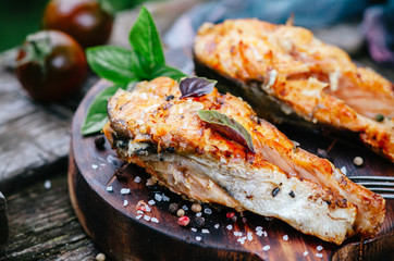 Grilled salmon on a wooden board on an old table
