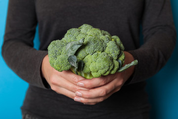 Naklejka na ściany i meble Tree broccoli in hands, beauty antioxidant vegetarian food.