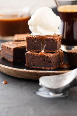 Chocolate brownies with salted caramel, vanilla ice cream. Copy space.