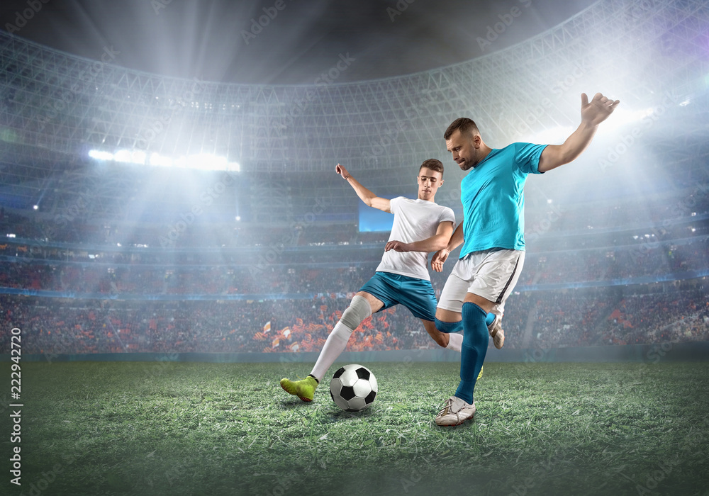 Wall mural soccer player on a football field in dynamic action at summer da