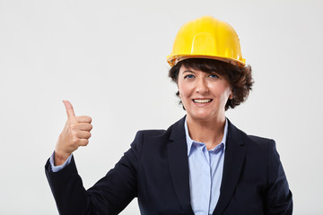 Mature engineer woman showing thumbs up