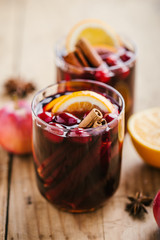 Mulled wine in glass on wooden table