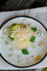 Appetizer with pear, blue cheese and pine nuts