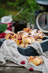 Buns with raspberries and powdered sugar in rustic style