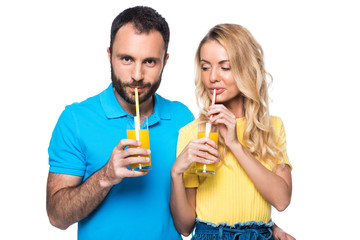 couple drinking orange juice with straws isolated on white