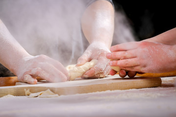 Making dough by female hands at home in kitchen
