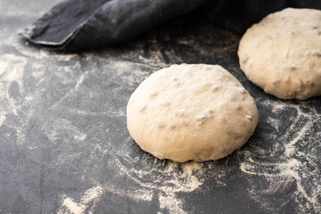 Fototapeta na wymiar Balls of dough covered with wheat flour ready for baking. Copy space.