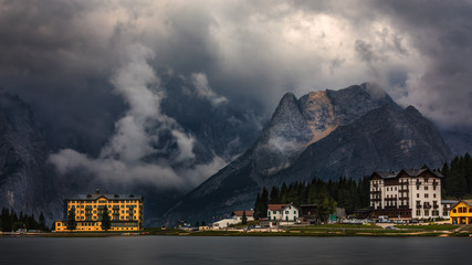 Fototapeta premium Misurina Lake in the Dolomites mountains in Italy near Auronzo di Cadore on a cloudy day, Sorapiss mountain in the background. South Tyrol, Dolomites, Italy.
