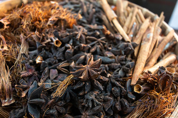 Red cotton tree flowers dried and Cinnamon with star aniseed in Bamboo basket

