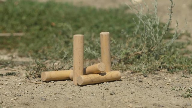 Traditional Russian game GORODKI. Bita knocks down the figure Slow Motion video