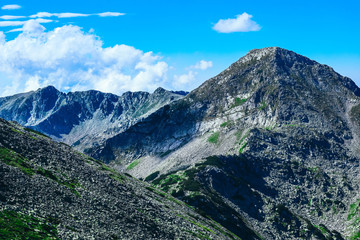 Fototapeta na wymiar Beautiful alpine high mountains peaks, blue sky background. Amazing Mountain hiking paradise landscape, summertime.